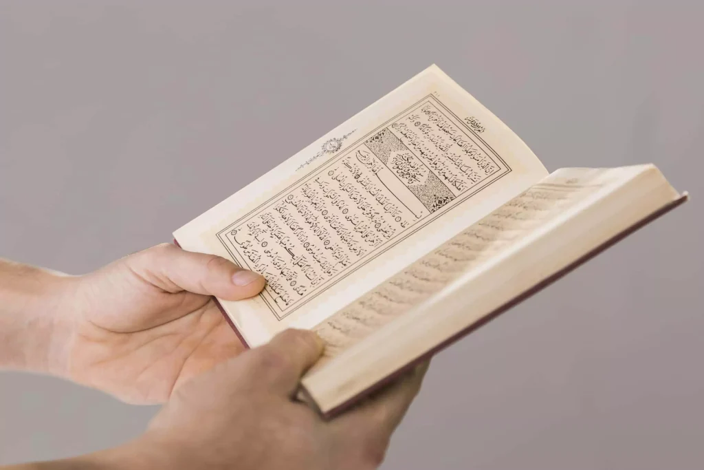 Why the Quran is Indispensable for Every Muslim? 8 Muslim holding and reading the Quran with devotion
